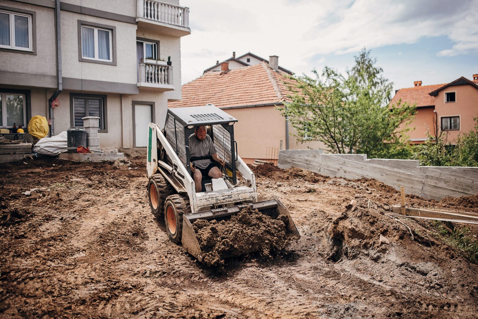 Small bulldozer working on muddy ground.