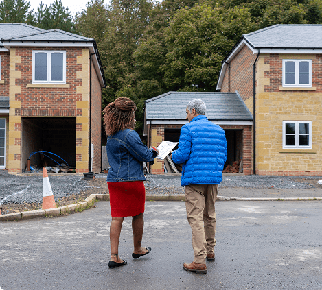 Two people inspecting new residential construction.