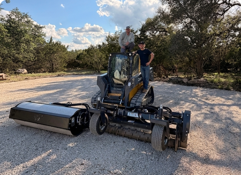 Gravel driveway with equipment and two men