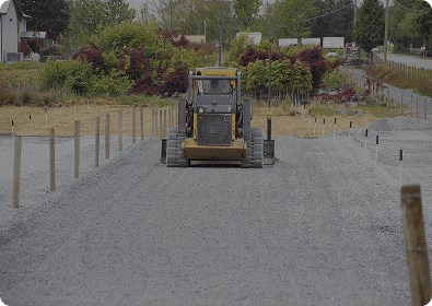 Yellow dozer smoothing gravel pathway
