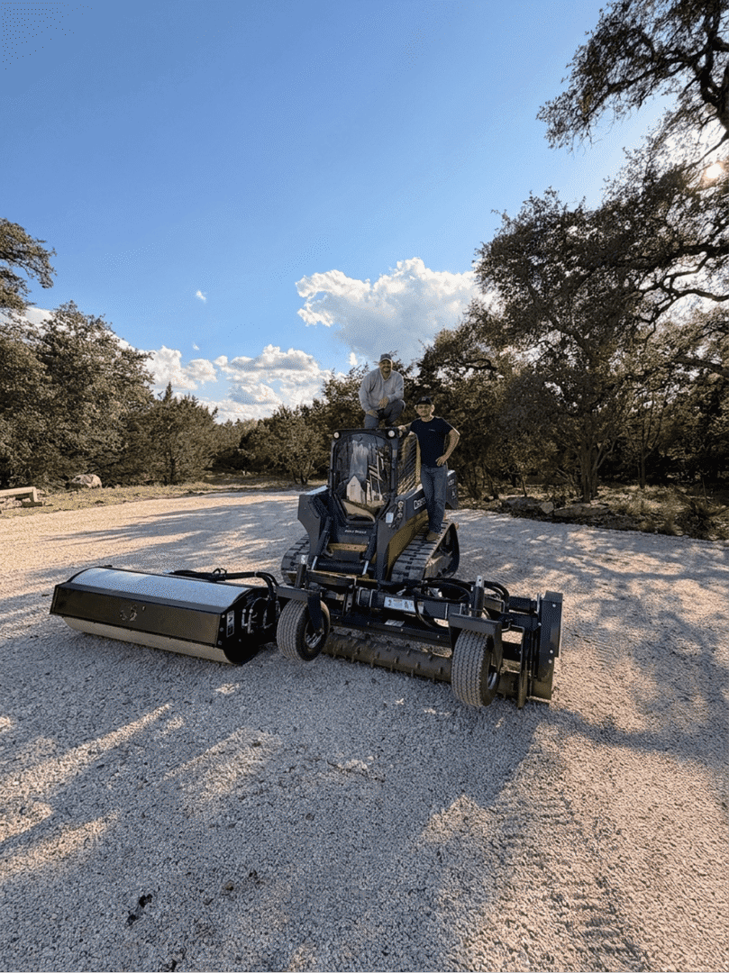 Two men on compact tracked loader
